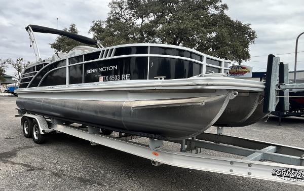 Bennington 23LTFB 2022 Bennington 23LTFB pontoon boat on trailer, parked outdoors.