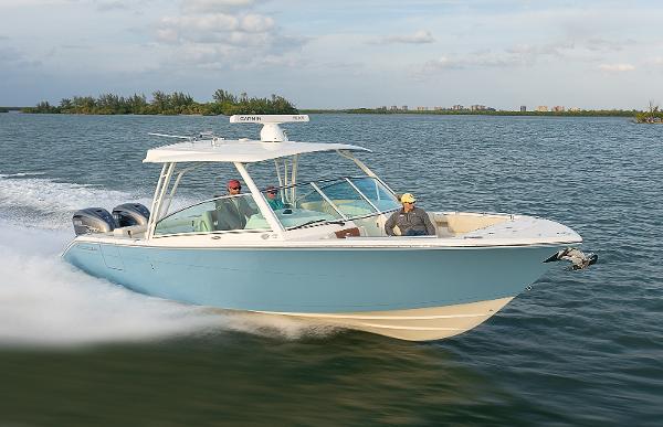 Cobia 330 Dual Console 2024 Cobia 330 Dual Console boat cruising on open water.