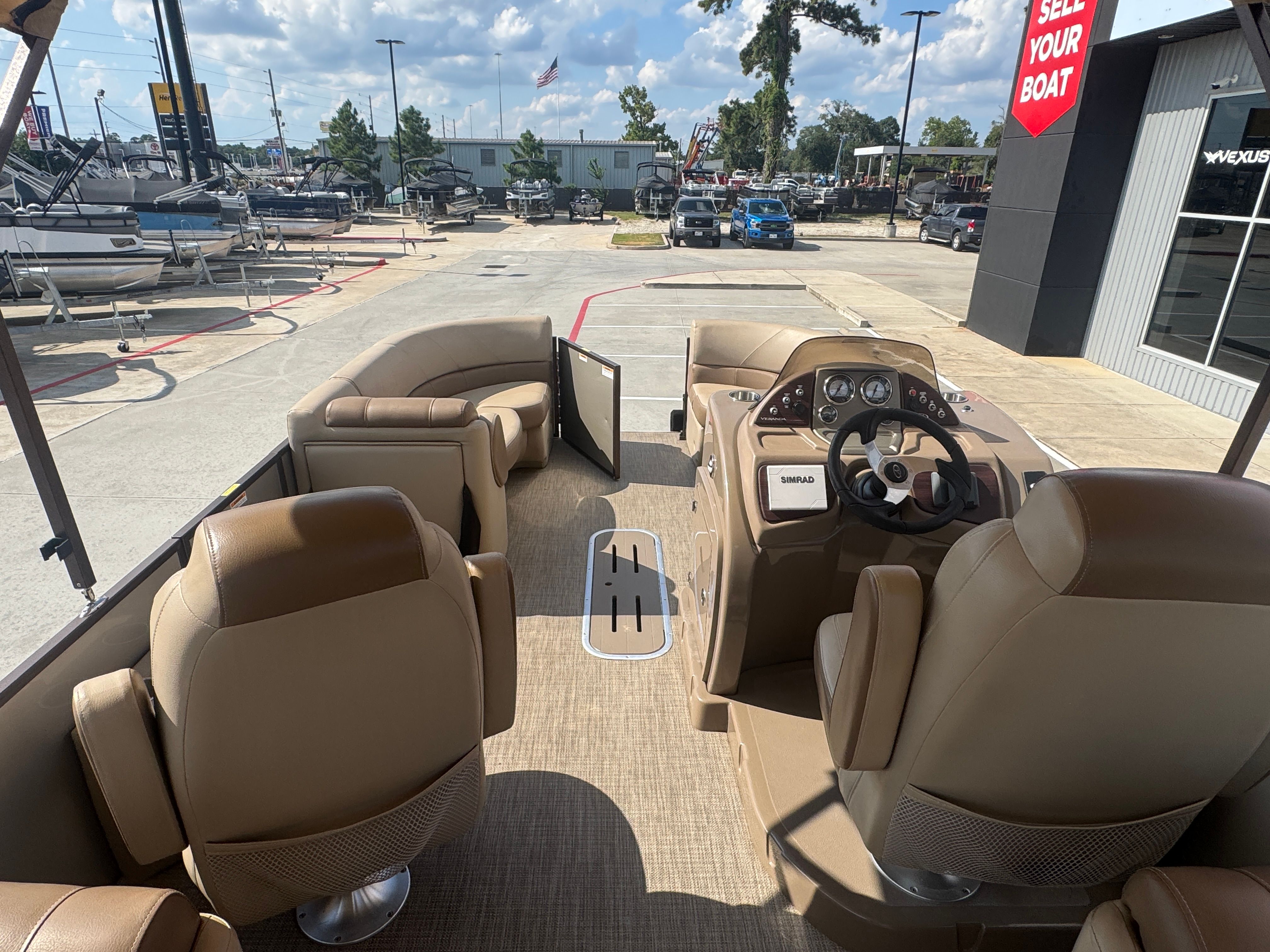 Veranda V2275RC Interior of a 2017 Veranda V2275RC pontoon boat with beige seating and steering console.