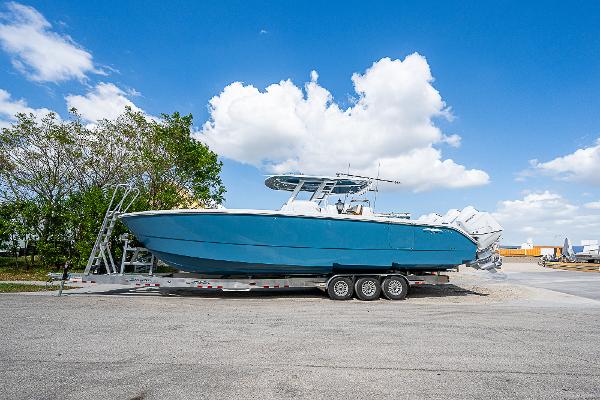 Invincible 38 Catamaran 2025 Invincible 38 Catamaran on trailer, blue hull, parked outdoors under clear sky.