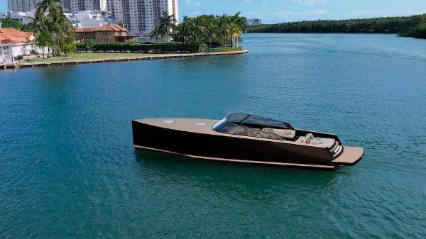 VanDutch 56 Luxurious 2025 VanDutch 56 yacht cruising on a serene waterway near modern buildings.
