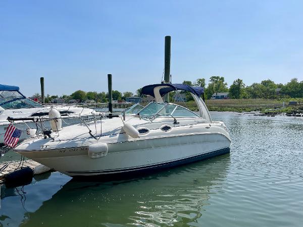 Sea Ray 260 Sundancer 2004 Sea Ray 260 Sundancer boat docked in a serene marina setting.