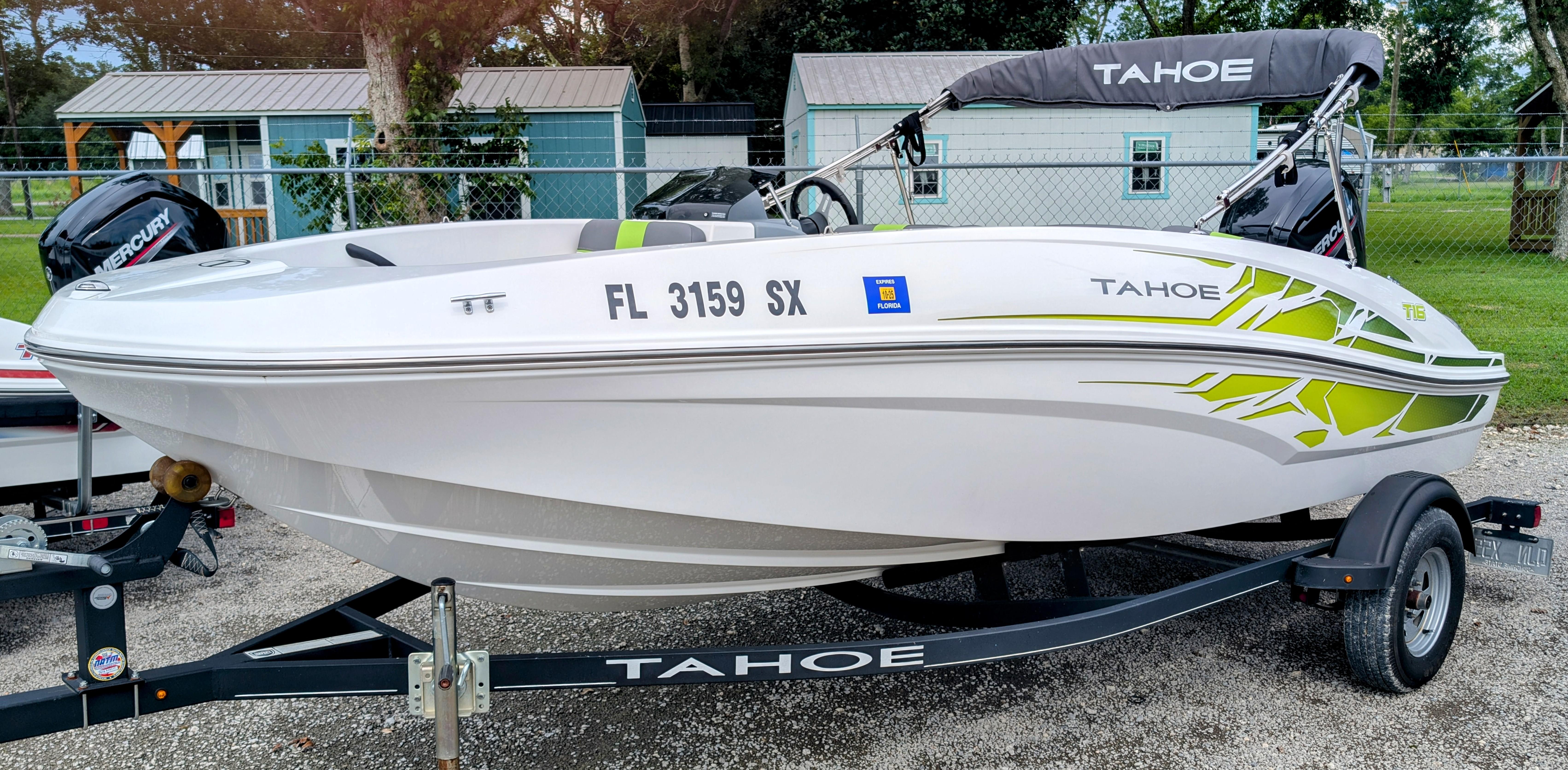 Tahoe T16 2021 Tahoe T16 boat on trailer with green accents, parked outdoors.