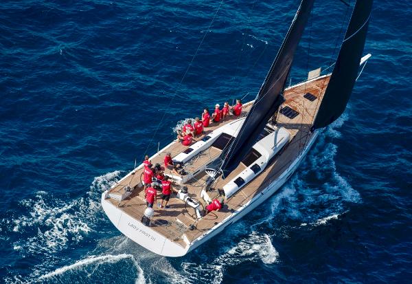Mylius 60 FD Aerial view of 2018 Mylius 60 FD yacht sailing with crew in red attire.