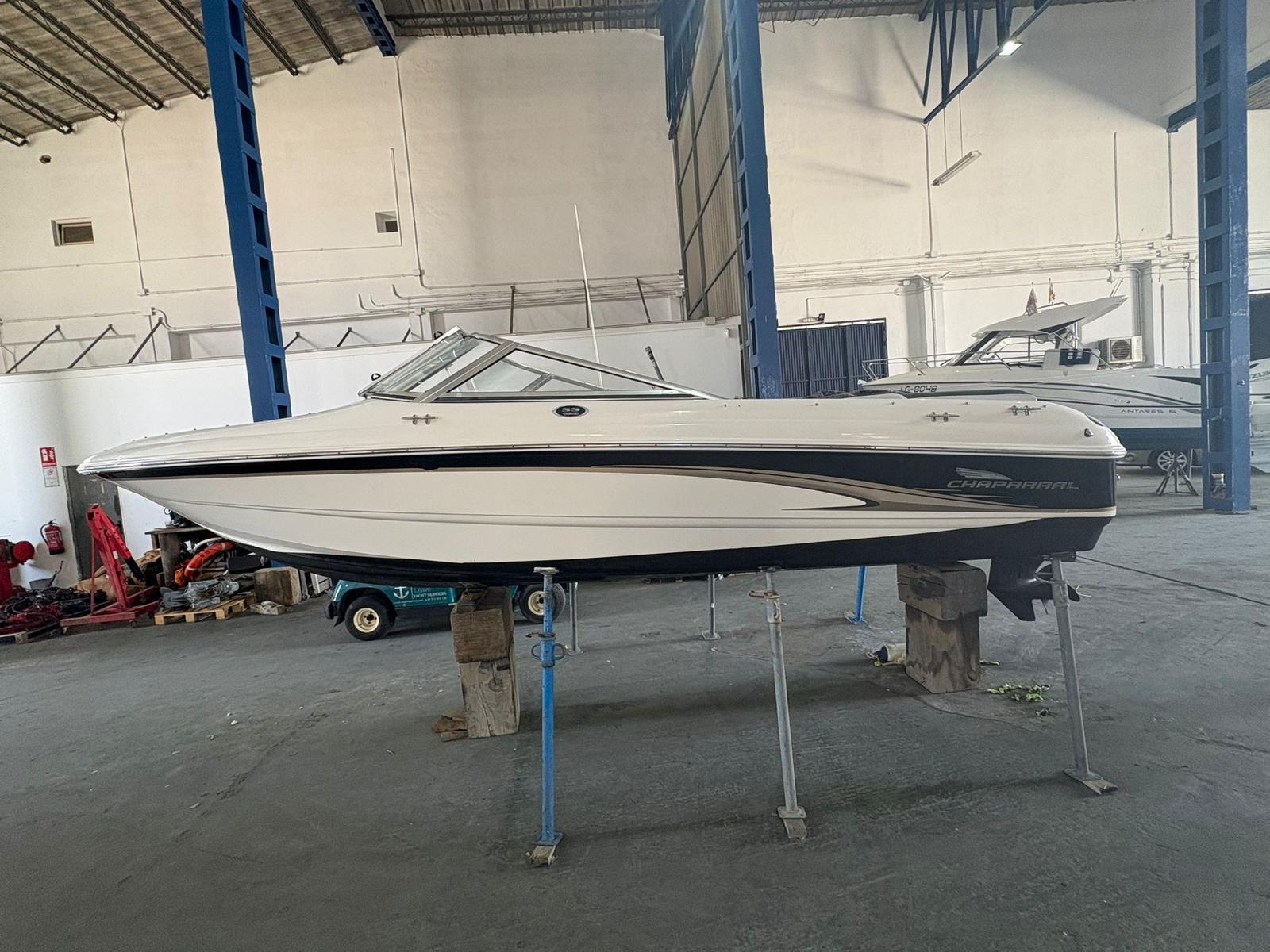 Chaparral 180SS 2003 Chaparral 180SS boat in a warehouse, elevated on stands.