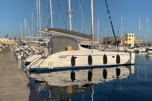 Fountaine Pajot LAVEZZI 40 2002 Fountaine Pajot LAVEZZI 40 catamaran docked at marina, reflecting on calm water.