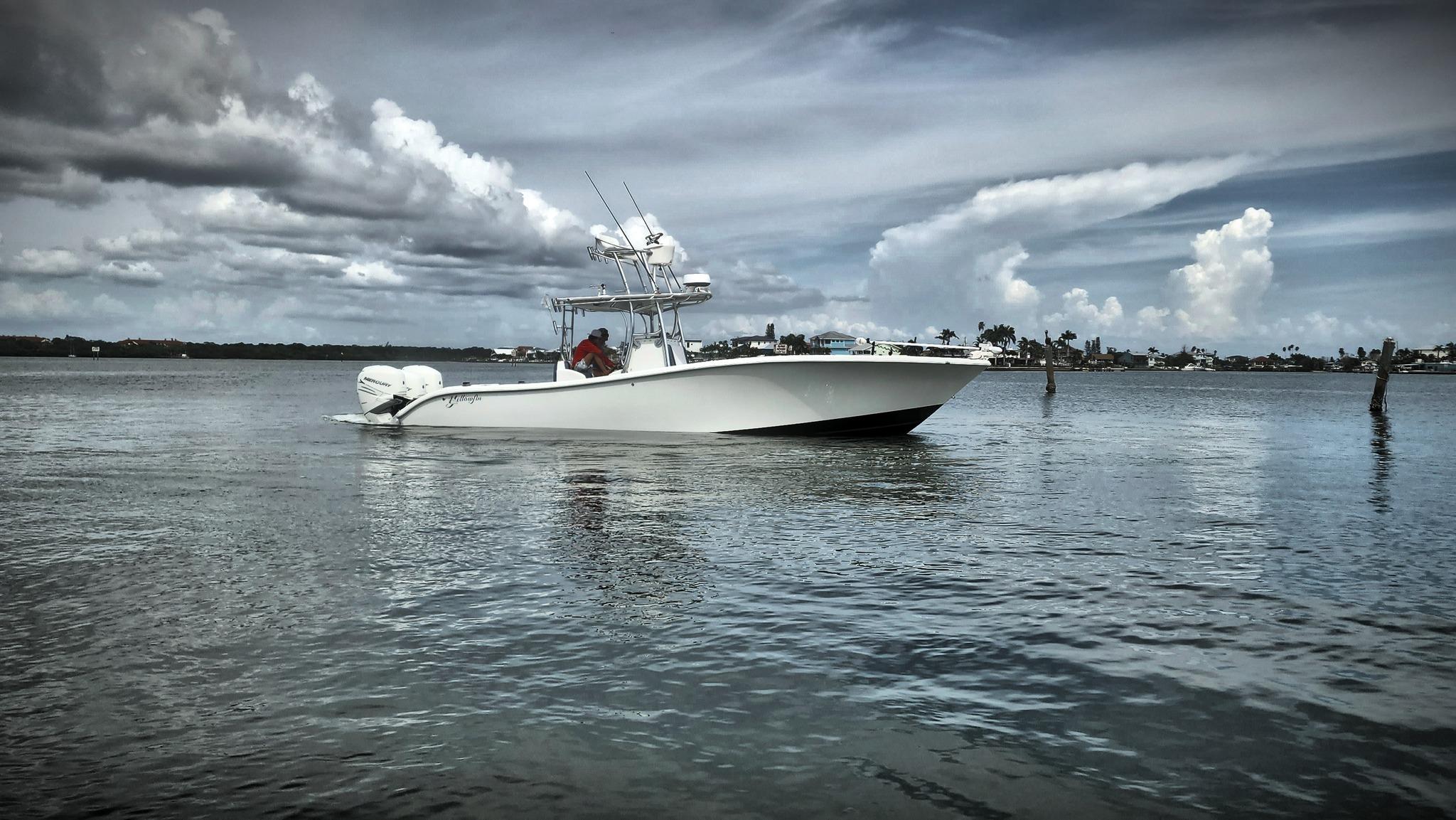 Yellowfin 34 2006 Yellowfin 34 boat cruising on calm waters under a cloudy sky.