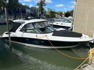 Sea Ray 350 SLX 2016 Sea Ray 350 SLX boat docked in a marina, featuring sleek design and black hull.