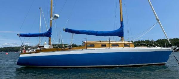 Classic 36 Controversy 36 C/C Yawl Classic 1959 36 Controversy C/C Yawl sailboat with blue hull and wooden accents on water.