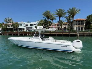 Intrepid 32 Open 2012 Intrepid 32 Open boat on water near luxury waterfront homes.