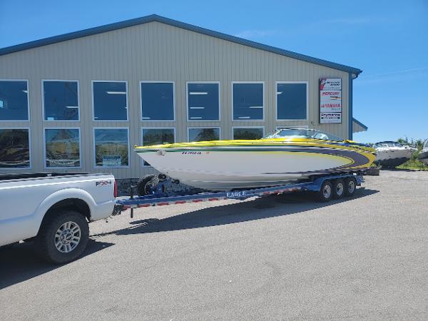 Formula 353 FASTech 1998 Formula 353 FASTech boat on trailer outside a building.