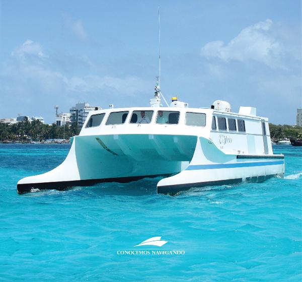 Gold Coast 70 Wave Piercer 2014 Gold Coast 70 Wave Piercer catamaran on turquoise water near city shoreline.