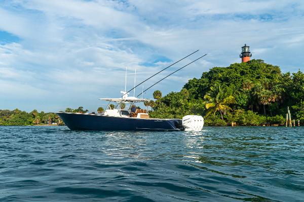 Valhalla Boatworks V-41 2026 Valhalla Boatworks V-41 cruising near a lush island with a lighthouse.