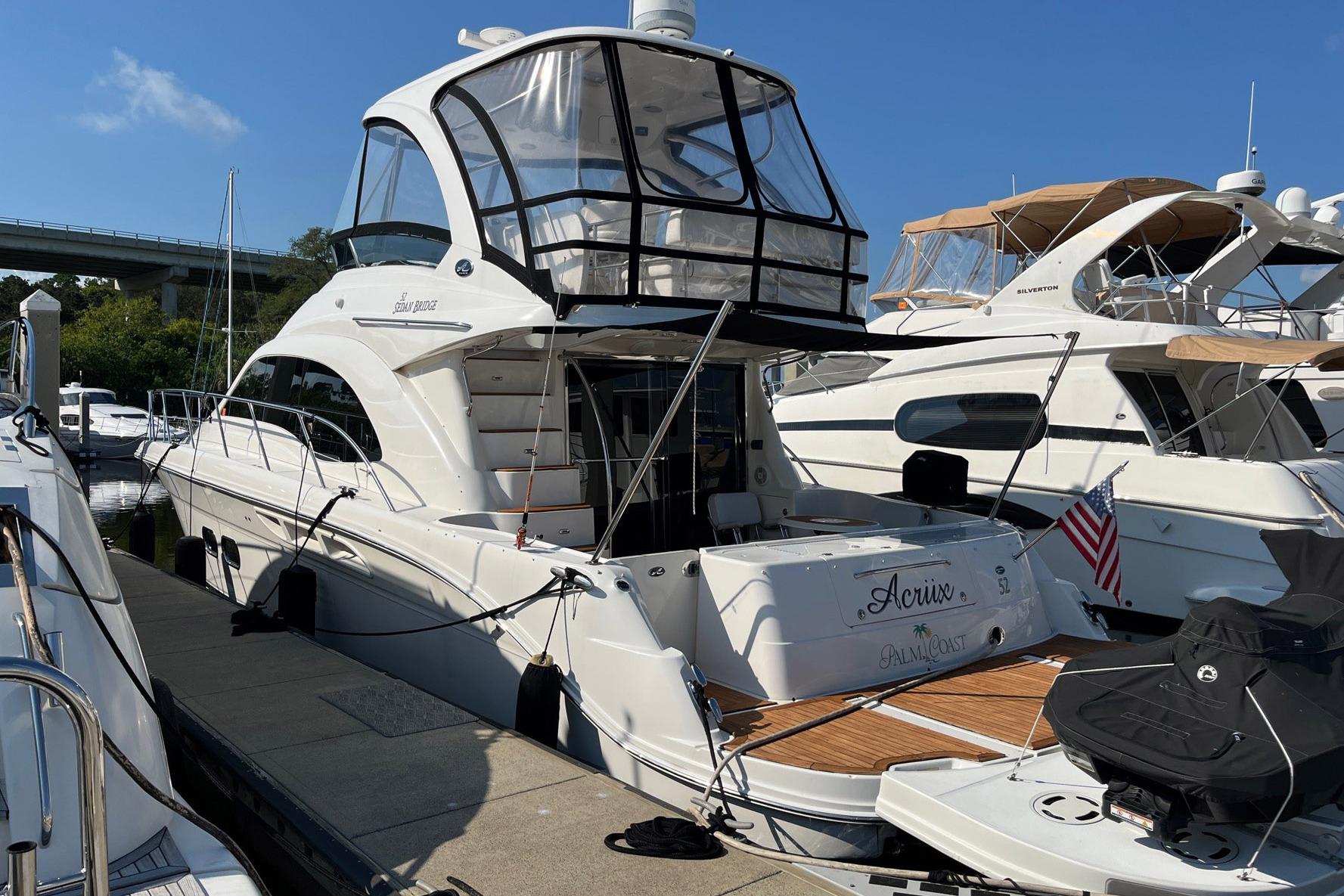 Sea Ray 52 Sedan Bridge 2007 Sea Ray 52 Sedan Bridge yacht docked at marina, featuring sleek design and American flag.