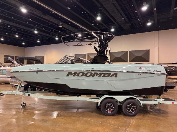 Moomba Max 2025 Moomba Max boat on display in an indoor showroom.
