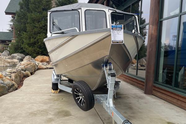 Spartan 215 Athens 2024 Spartan 215 Athens boat on trailer, displayed outdoors near building.