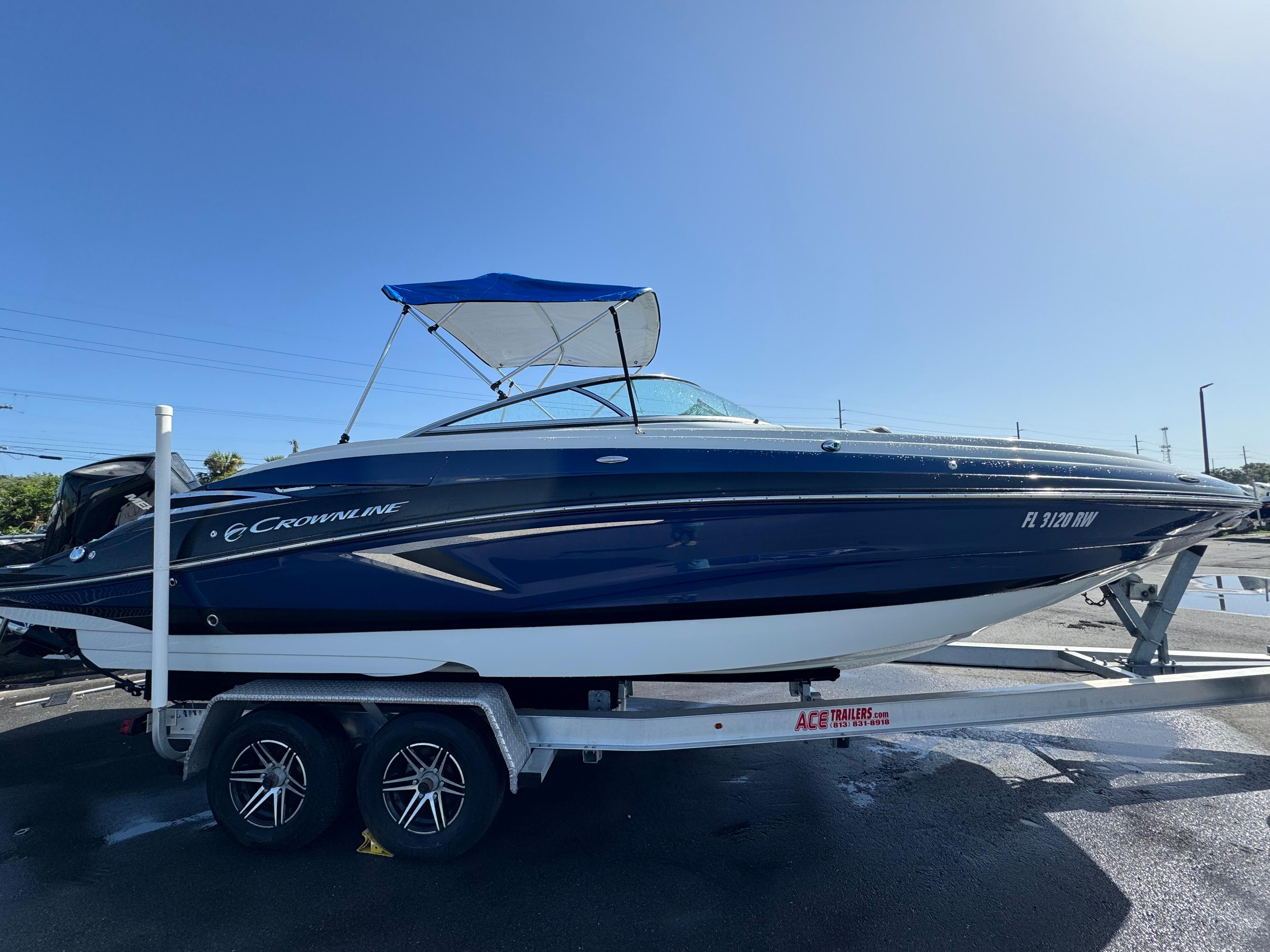 Crownline Eclipse E255 XS 2019 Crownline Eclipse E255 XS boat on trailer under clear blue sky.