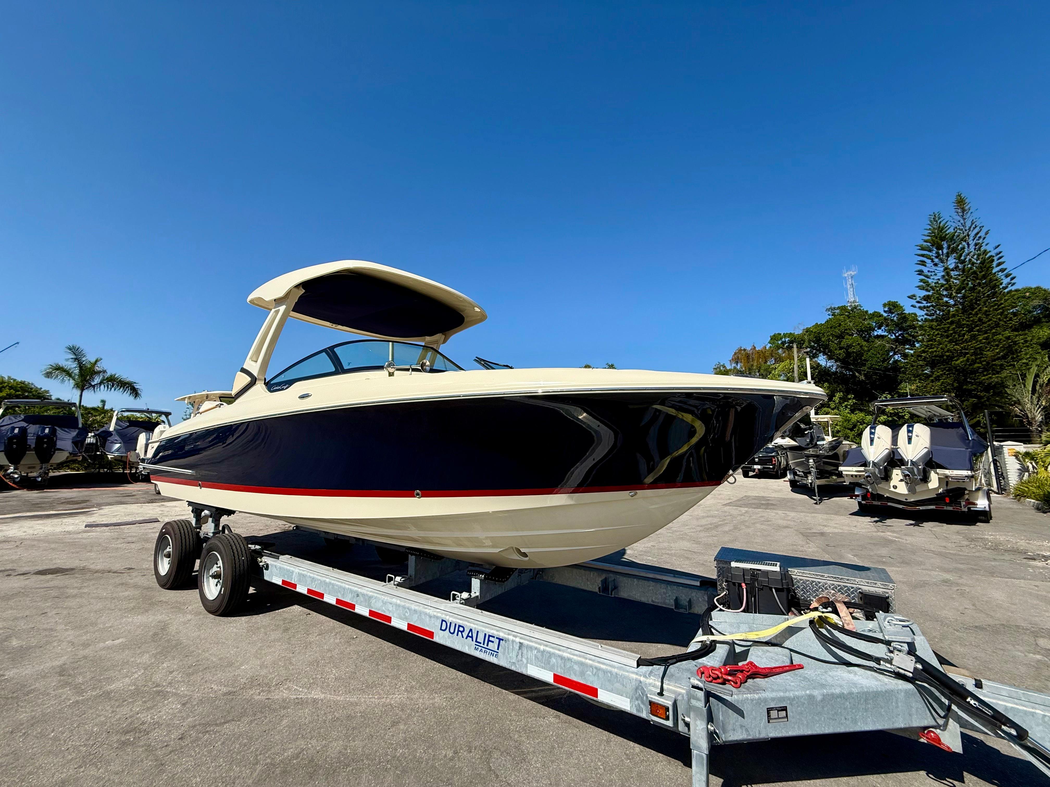 Chris-Craft 28 sportster 2025 Chris-Craft 28 Sportster boat on trailer under clear blue sky.