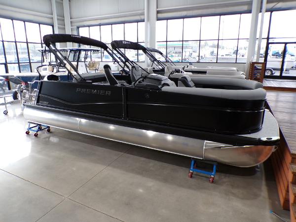 Premier 230 Sunsation RL 2025 Premier 230 Sunsation RL pontoon boat in showroom, sleek black design.