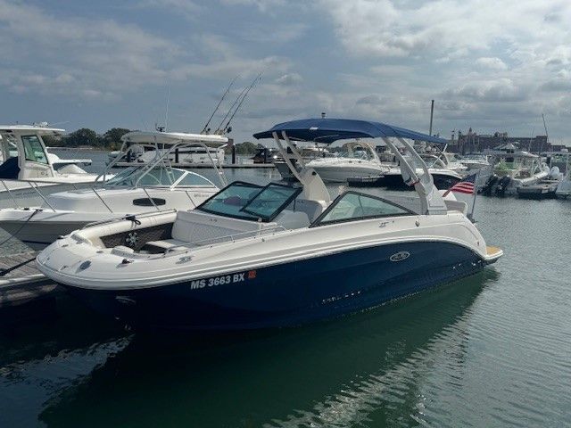 Sea Ray SDX 250 Outboard 2019 Sea Ray SDX 250 Outboard boat docked in a marina under cloudy skies.