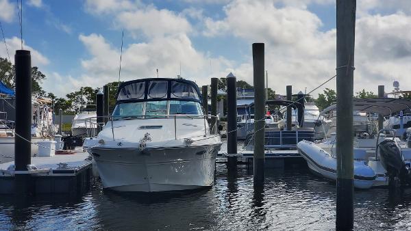 Sea Ray 310 Sundancer 2001 Sea Ray 310 Sundancer docked at marina under cloudy sky.
