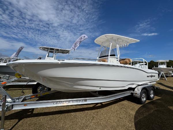 NauticStar 231 Hybrid 2025 NauticStar 231 Hybrid boat on trailer under blue sky.