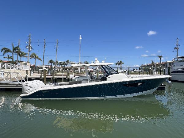 Pursuit S 378 Sport 2023 Pursuit S 378 Sport boat docked in a marina under clear blue skies.