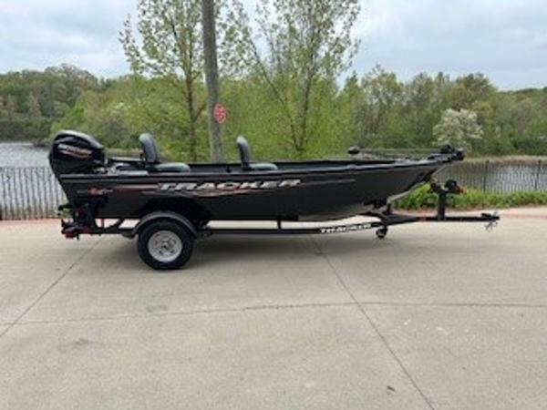 Tracker Super Guide V-16 T 2025 Tracker Super Guide V-16 T boat on trailer, parked near a scenic lake.