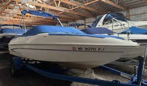 Glastron MX 195 2006 Glastron MX 195 boat with blue cover in storage facility.