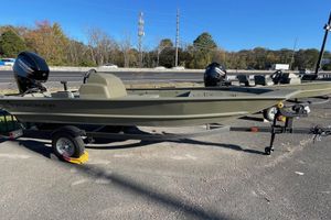 Tracker Grizzly 1754 SC 2026 Tracker Grizzly 1754 SC boat on trailer, parked outdoors, with Mercury outboard motor.