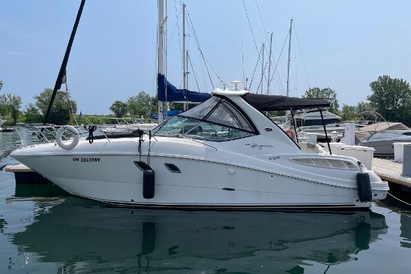 Sea Ray 310 Sundancer 2007 Sea Ray 310 Sundancer boat docked in a marina, surrounded by other vessels.