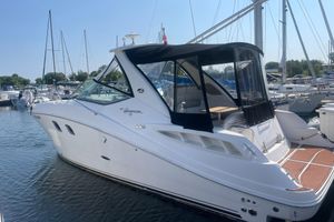 Sea Ray 310 Sundancer 2007 Sea Ray 310 Sundancer boat docked in a marina, featuring sleek design and canopy.