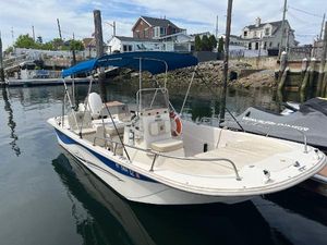 Carolina Skiff 198 DLV 2018 Carolina Skiff 198 DLV boat docked in a marina with blue canopy.