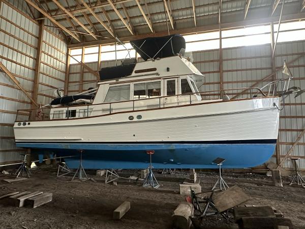 Grand Banks 36 Classic 1978 Grand Banks 36 Classic boat in storage, elevated on stands, inside a wooden structure.