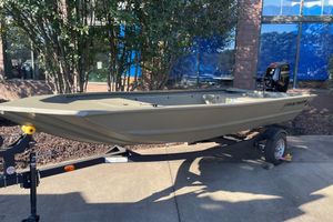 Tracker Grizzly 1648 Utility 2026 Tracker Grizzly 1648 Utility boat on trailer, outdoors, with Mercury outboard motor.