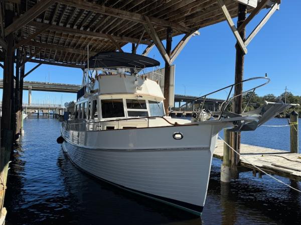 Grand Banks 49 Motor Yacht 1986 Grand Banks 49 Motor Yacht docked under a wooden shelter.