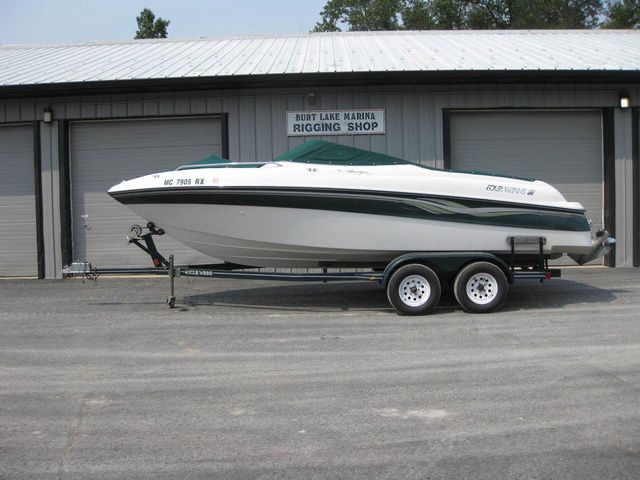 Four Winns 220 HORIZON I/O W/Trailer 1999 Four Winns 220 Horizon boat on trailer at marina rigging shop.