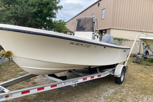 Parker 1801 Center Console 1991 Parker 1801 Center Console boat on trailer, parked outdoors near a building.