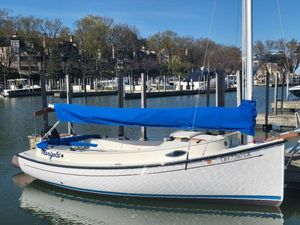 Com-Pac Horizon Cat 20 2023 Com-Pac Horizon Cat 20 sailboat docked with blue cover in a marina.
