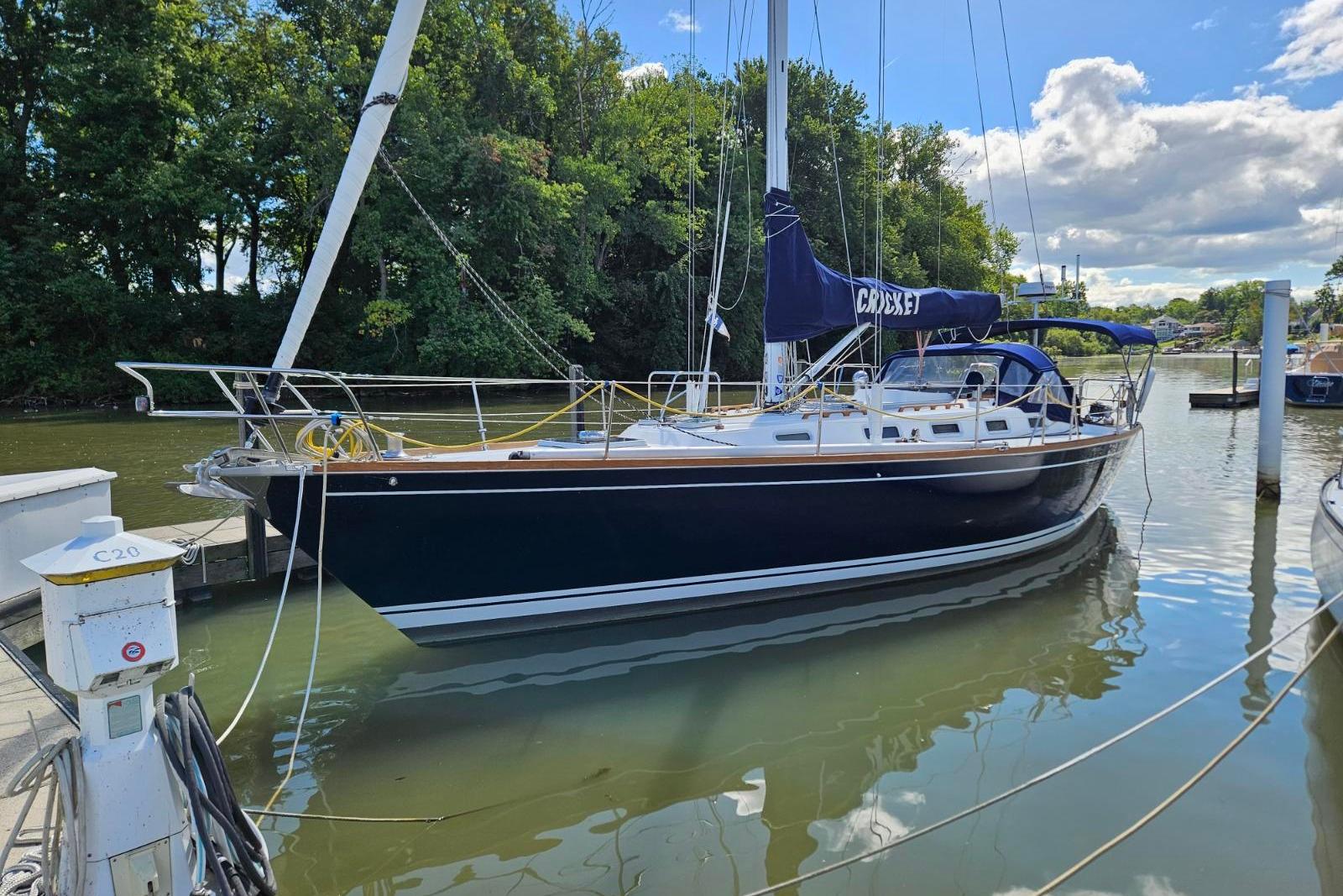 Tartan 40 1988 Tartan 40 sailboat docked in a serene marina setting.