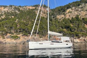 Beneteau Oceanis 41 2013 Beneteau Oceanis 41 sailboat on calm water, scenic rocky forested backdrop.