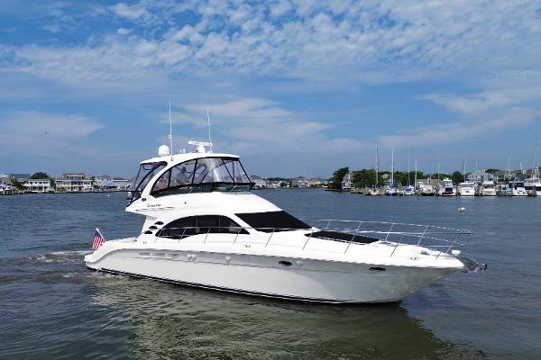 Sea Ray 52 Sedan Bridge 2007 Sea Ray 52 Sedan Bridge yacht cruising in a marina under a blue sky.