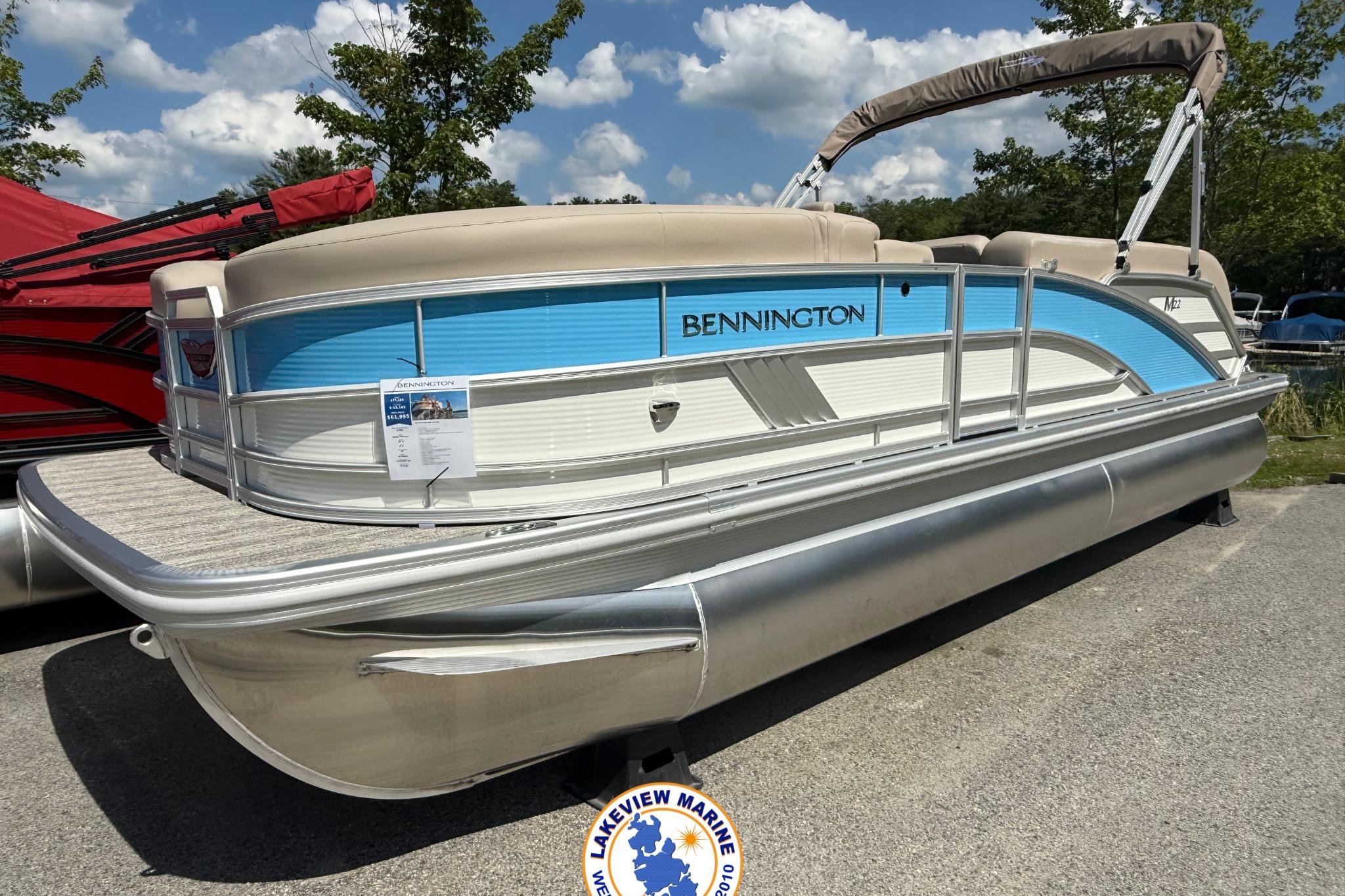 Bennington 22ML 2025 Bennington 22ML pontoon boat with blue accents displayed outdoors.