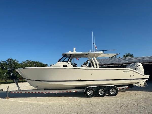 Pursuit S 358 Sport 2024 Pursuit S 358 Sport boat on trailer, parked outdoors under clear blue sky.