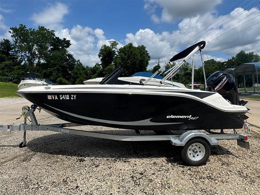 Bayliner Element M17 2023 Bayliner Element M17 boat on trailer, parked outdoors under a cloudy sky.