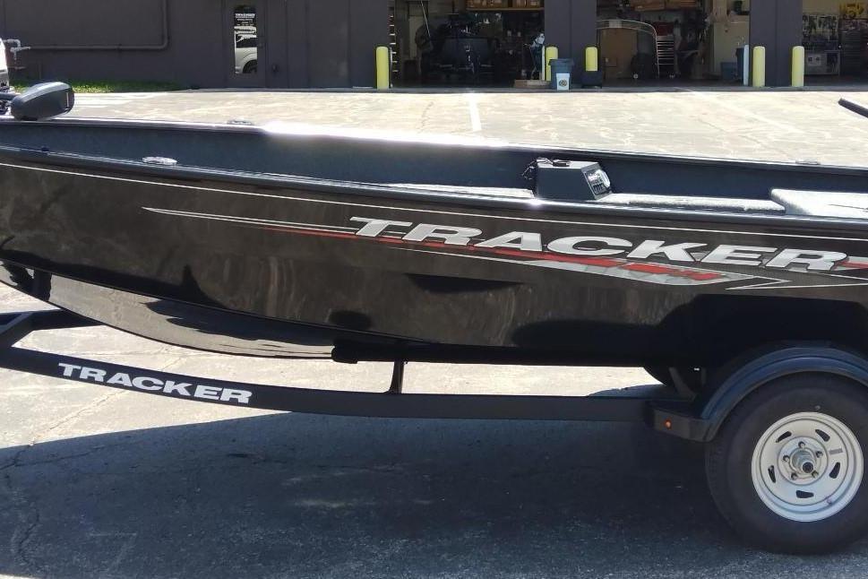 Tracker Super Guide V-16 T 2025 Tracker Super Guide V-16 T boat on trailer, black exterior, parked outdoors.