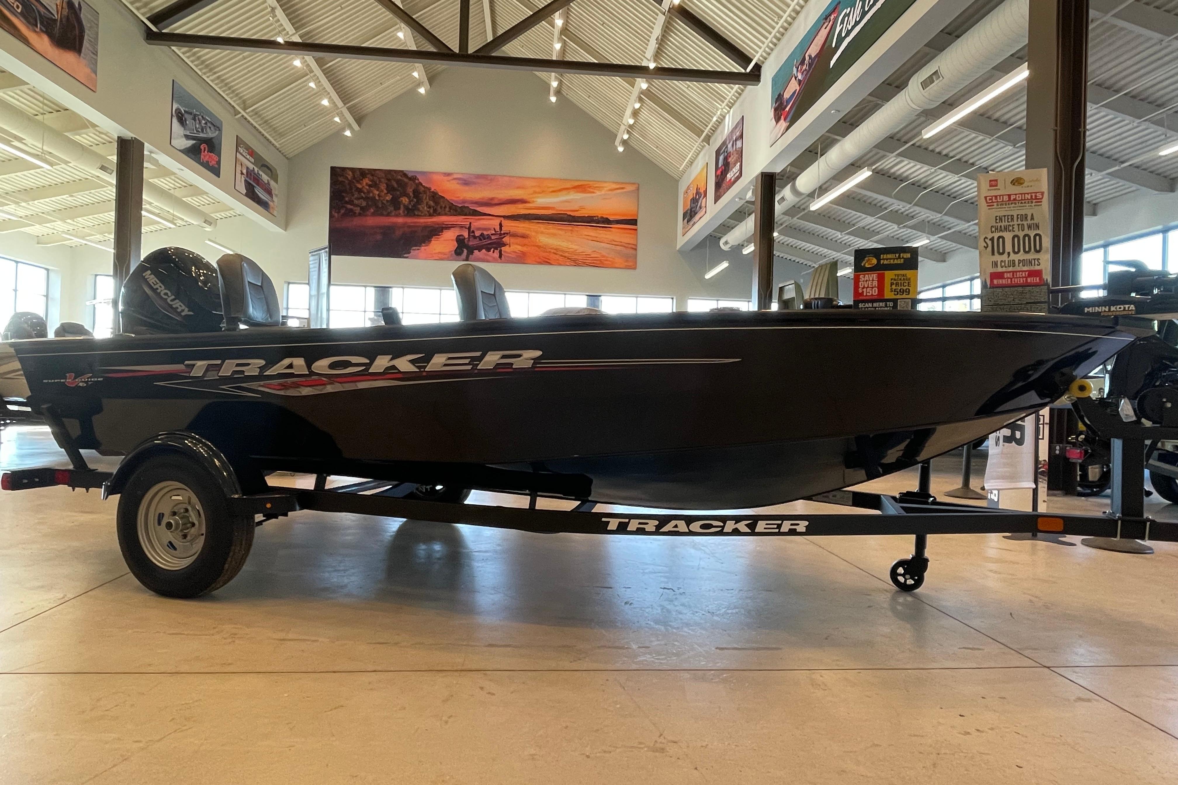 Tracker Super Guide V-16 T 2025 Tracker Super Guide V-16 T boat displayed in a showroom.