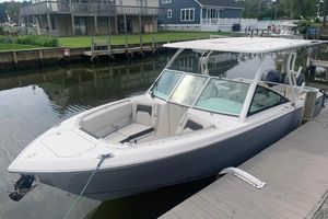 Sailfish 276 DC 2023 Sailfish 276 DC boat docked by waterfront homes.