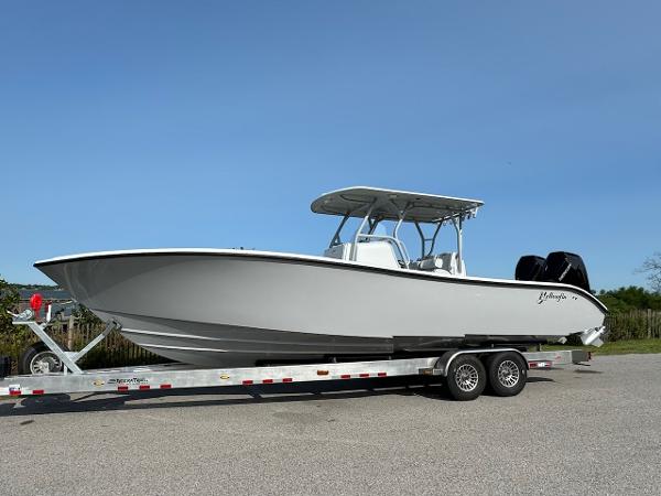 Yellowfin 32 Offshore 2025 Yellowfin 32 Offshore boat on trailer, side view, clear sky background.