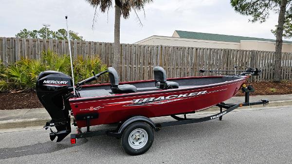 Tracker Super Guide V-16 T 2025 Tracker Super Guide V-16 T boat with Mercury engine on trailer, parked outdoors.